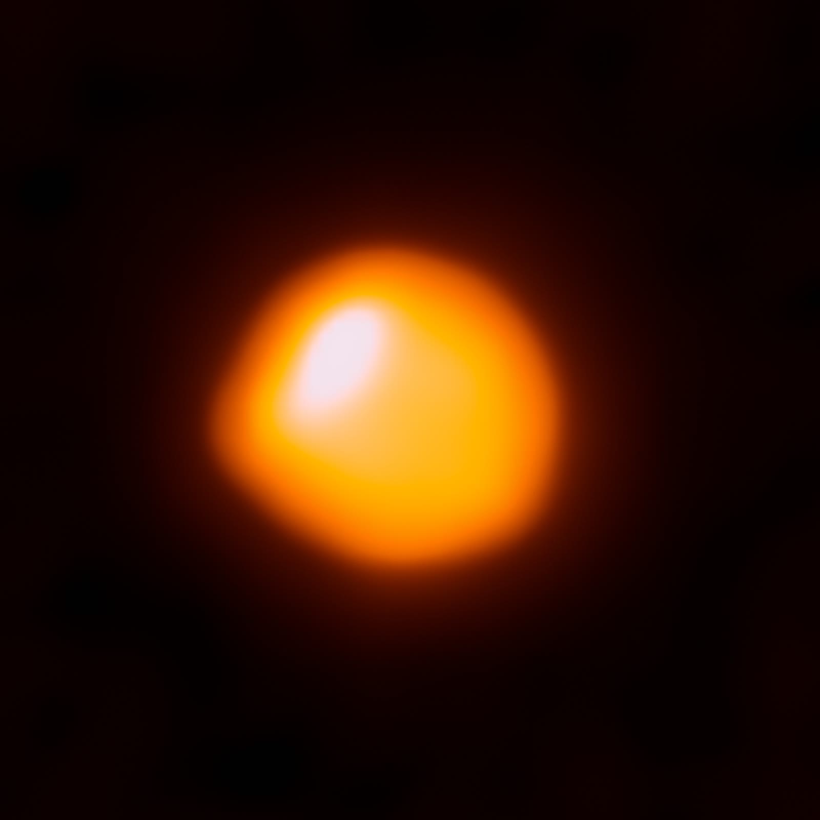 The red supergiant Betelgeuse seen by the ALMA radio telescope array, which resolves the star itself as a disc, with a hotter bright patch towards the upper left.