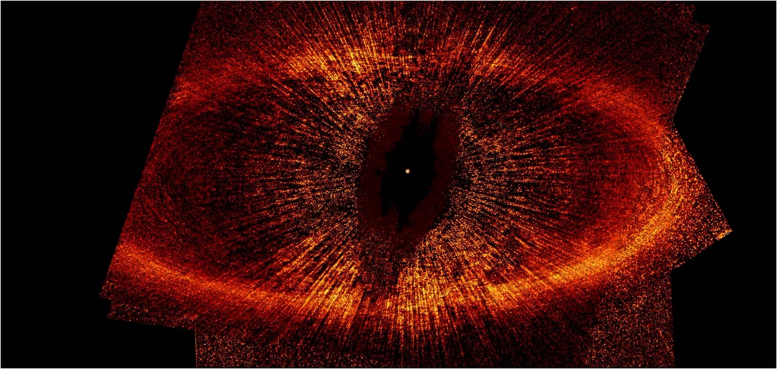 A Hubble Space Telescope image of the vast ring of dust around Fomalhaut; the star's glare is blocked out, and its position is marked by the small dot at the centre of the ring.
