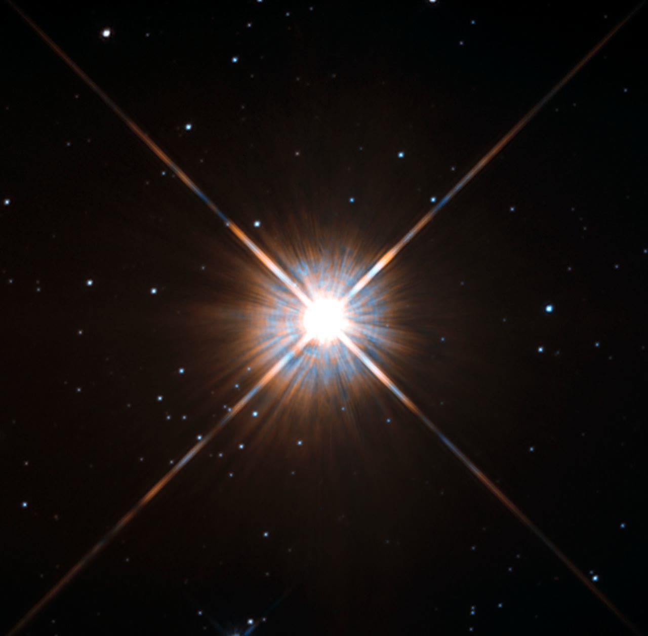 Proxima Centauri, the closest star to the Sun, shines at the centre of this Hubble Space Telescope image with background stars scattered around it.