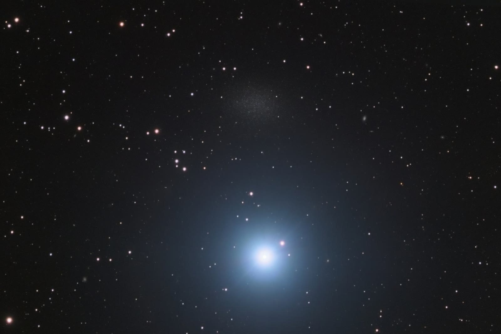 Regulus, the heart of Leo, shines in the lower centre, and the faint smudge just above it is Leo I, a small dwarf galaxy about 800,000 light-years away.